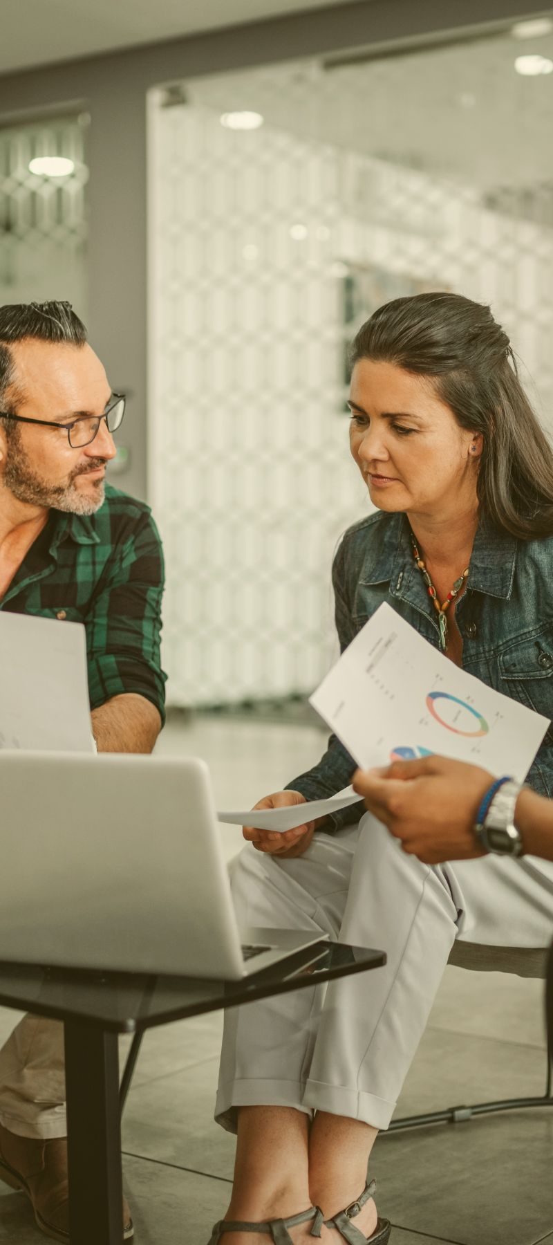 Two colleagues reviewing marketing reports together